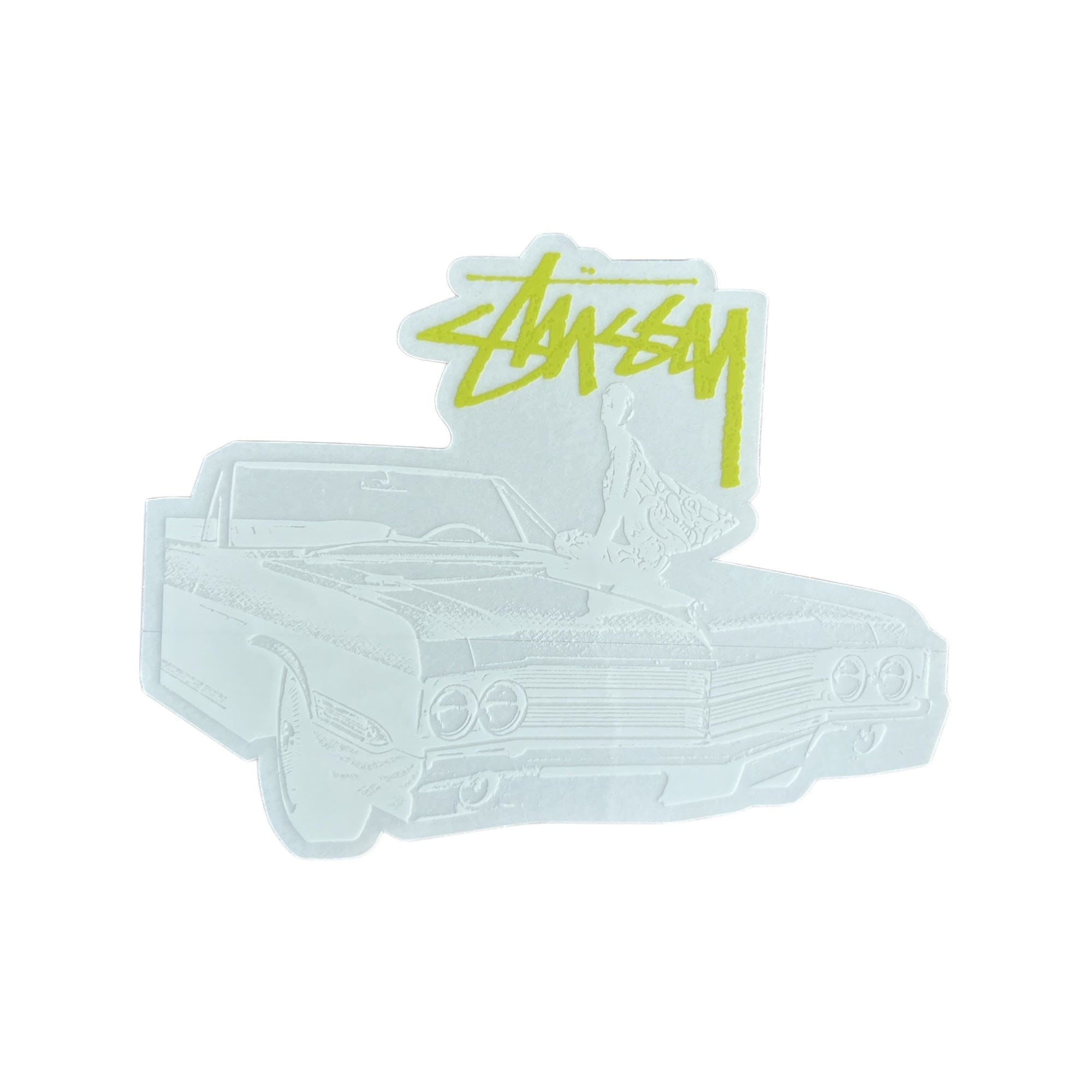 The image shows a sticker featuring a stylized black and white illustration of a classic convertible car with a person sitting on the hood, overlaid with the Stüssy logo in lemon lime.