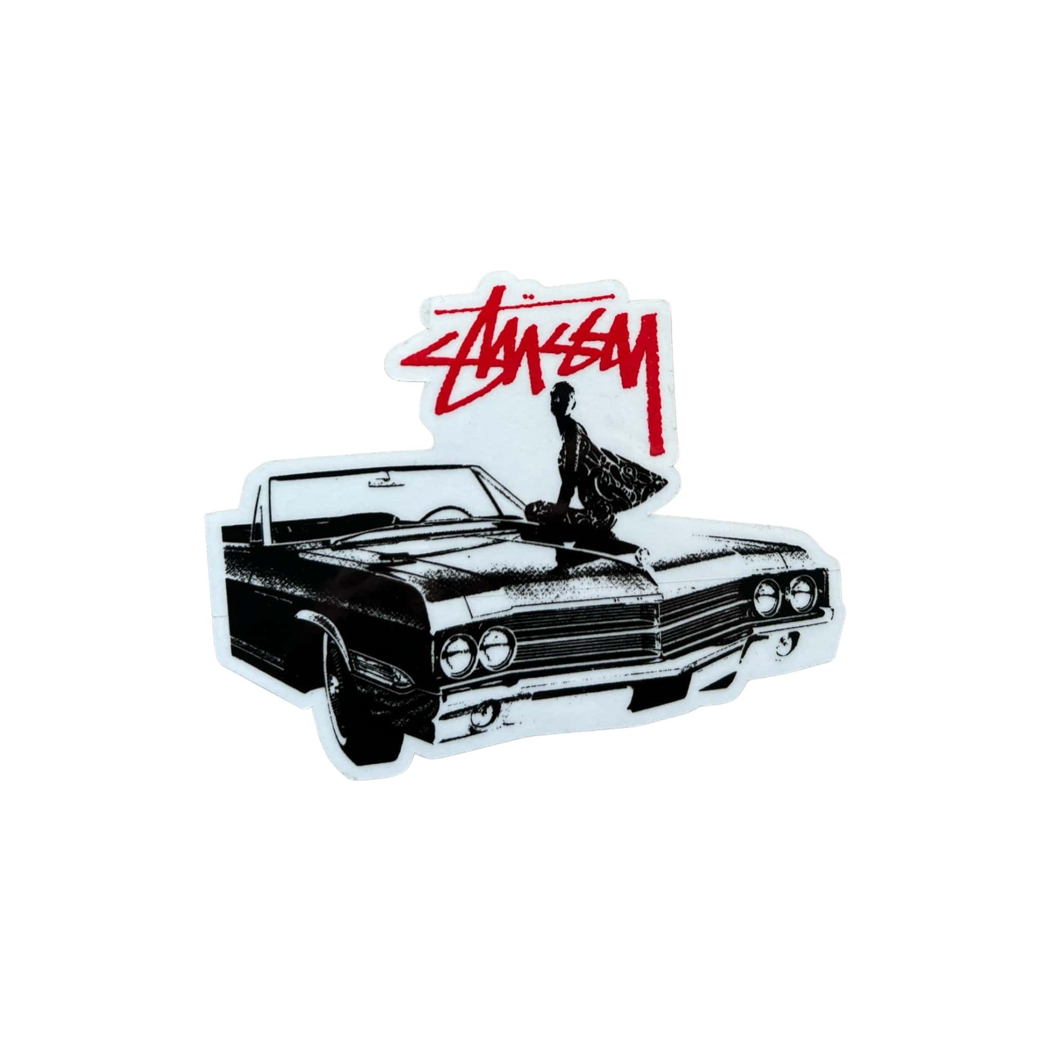 The image shows a sticker featuring a stylized black and white illustration of a classic convertible car with a person sitting on the hood, overlaid with the Stüssy logo in red.