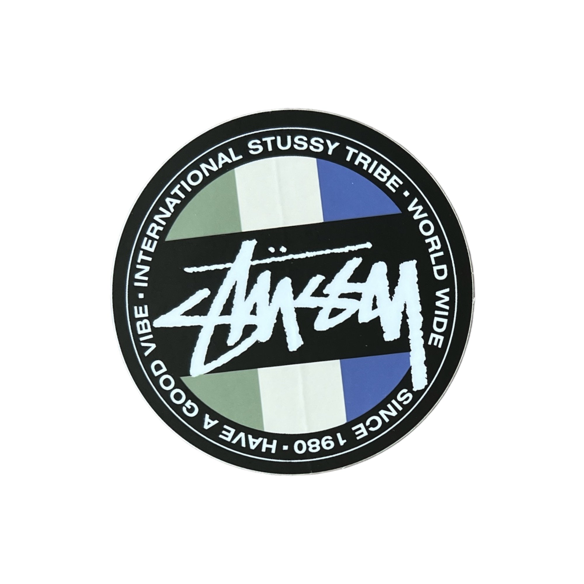 Stussy Tribe Worldwide Sticker in Green Yellow and Blue. The sticker measures 3"x3".